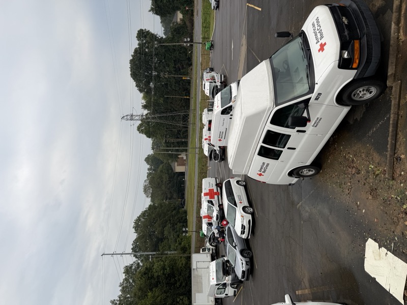 Red Cross response vehicles staged in a parking lot